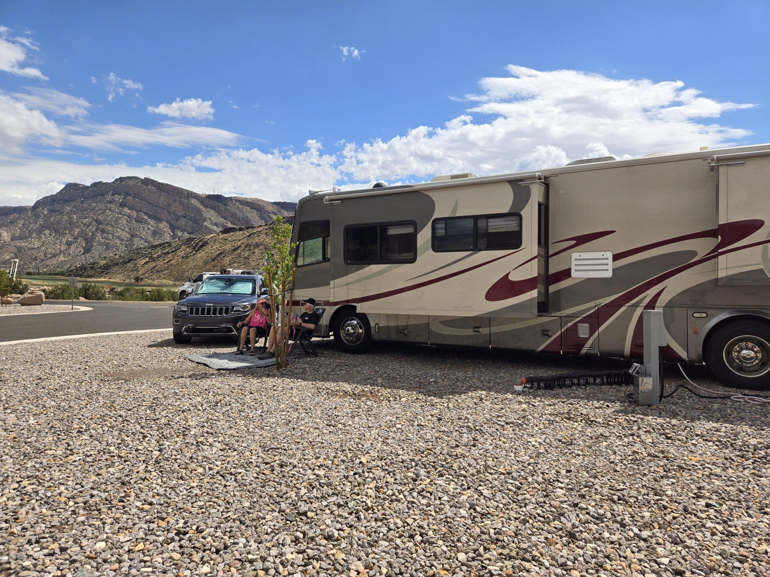 back of RV with two people staring at sunset