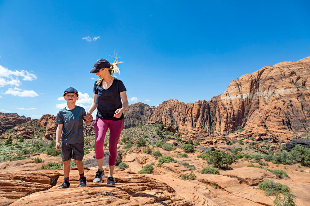 a mom and her child hike after camping near sand hollow state park utah
